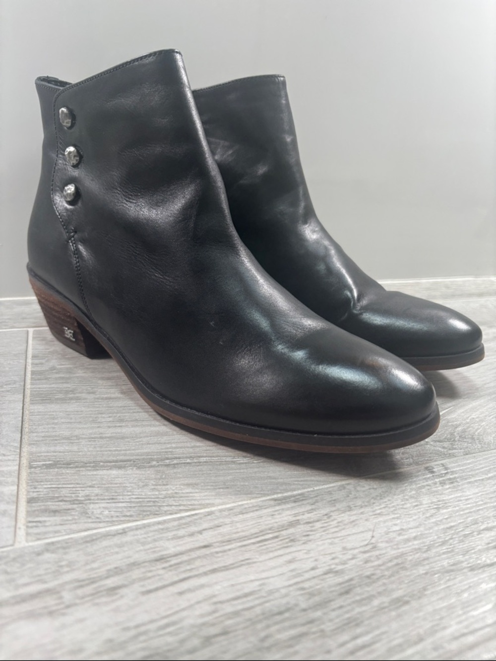 Sam Edelman black genuine leather ankle boots featuring a sleek almond toe, a co